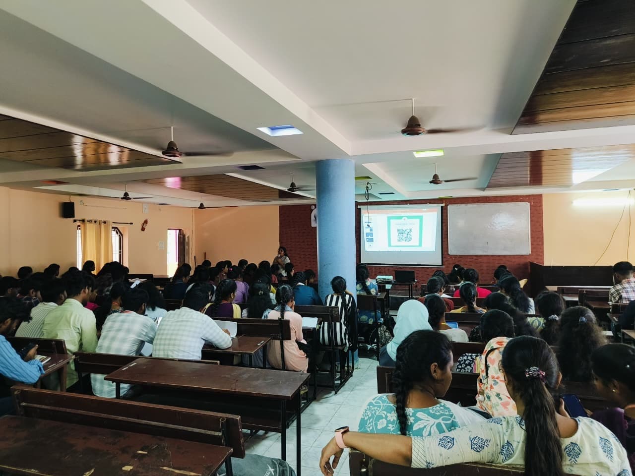 Students following a presentation on the projector during a campus session